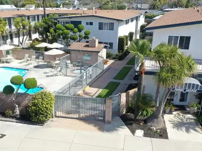 an aerial view of a resort with a pool and palm trees at Beautiful 2 Bed Beach Getaway #115 condo in Carpinteria