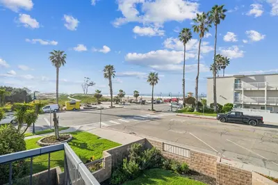 a view of a parking lot with palm trees at Beautiful 1 Bed Beach Condo #122 in Carpinteria