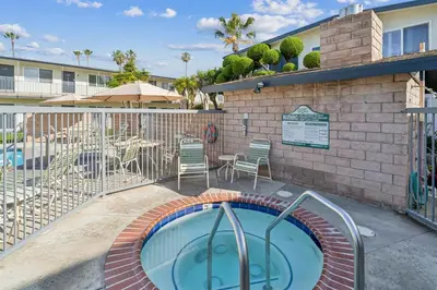 a swimming pool with a patio and a table and chairs at Beautiful 1 Bed Beach Condo #122 in Carpinteria