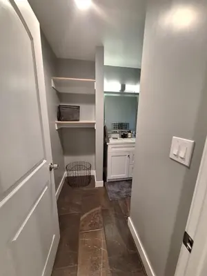 a room with a door and a kitchen with a counter at My amazing home in Azusa