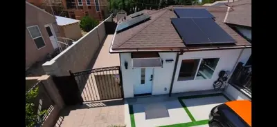 a small white house with solar panels on the roof at WG House Winnetka Los Angeles in Winnetka