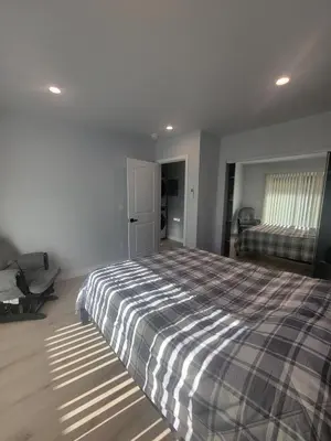 a bedroom with a bed with a checkered blanket at WG House Winnetka Los Angeles in Winnetka