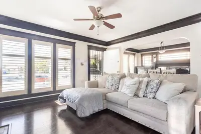 a living room with a couch and a ceiling fan at Urban Casita in Los Angeles