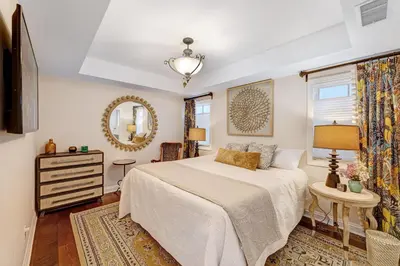 a bedroom with a bed and a mirror at Seventh Shore Stylish Seal Beach Home w Elevator Fireplace Bold Design in Seal Beach