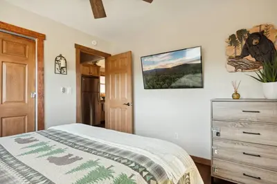 a bedroom with a bed and a dresser at Alpine Crest in Big Bear Lake in Big Bear Lake