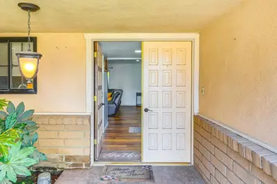 a door leading into a room with a hallway at 7 Mi to Dtwn Poolside Paradise in Bakersfield! in Bakersfield