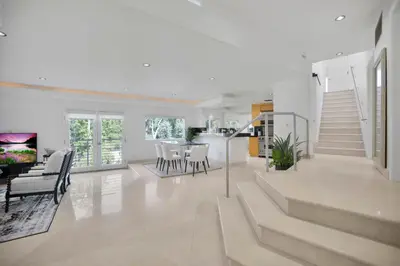 a living room with a staircase and a dining room at Belden View in Los Angeles