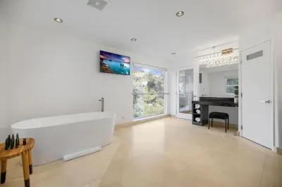 a large white bathroom with a tub and a piano at Belden View in Los Angeles