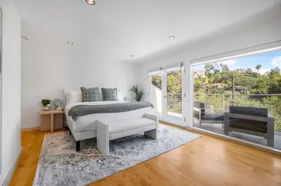 a white bedroom with a bed and a window at Belden View in Los Angeles