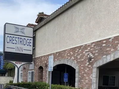 a sign on the side of a brick building at Crestridge Inn Near LAX, SoFi Stadium & Intuit Dome in Inglewood