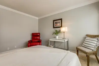 a bedroom with a bed and two chairs at Chic Coastal Home with Outdoor Oasis in Oxnard! in Oxnard