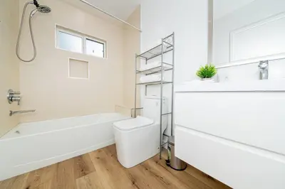 a bathroom with a tub and a toilet and a sink at NoHo Home Near Universal Studios in Burbank