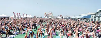 a large crowd of people doing yoga at aestival at The Andalusite - Oceanfront Steps from the Sand in Los Angeles