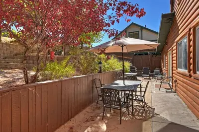 a patio with tables and chairs and an umbrella at Recreation Ridge-Next To Boulder Bay-HUGE in Big Bear Lake