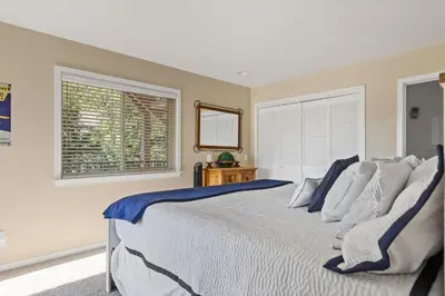 a bedroom with a large bed and a window at Bearfoot Lodge near Hiking & Skiing in Lake Arrowhead