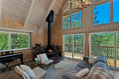 a living room with a couch and a fireplace at Casa Del Lago - Spacious 4 Story Gated Home in Lake Arrowhead