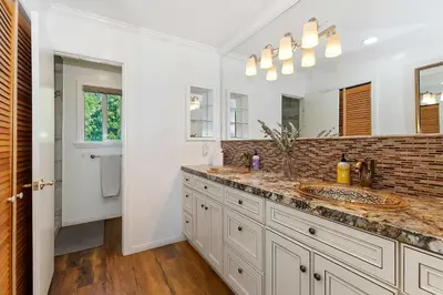 a bathroom with two sinks and a mirror at Casa Del Lago - Spacious 4 Story Gated Home in Lake Arrowhead