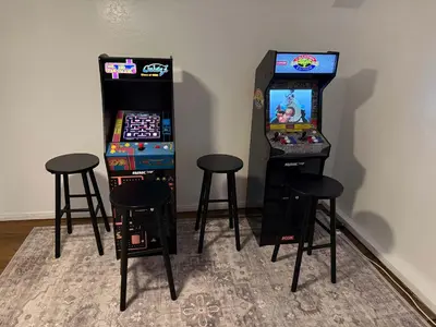 two arcade machines and two stools next to a video game at Casa Del Lago - Spacious 4 Story Gated Home in Lake Arrowhead