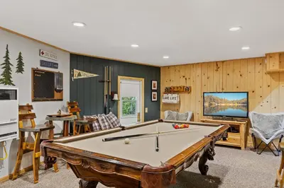 a room with a pool table and a tv at Chalet Vino - Snow Valley Mountain Resort in Green Valley Lake
