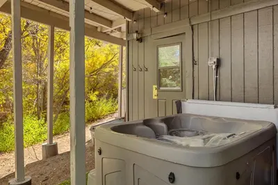 a bath tub sitting on the porch of a house at Chalet Vino - Snow Valley Mountain Resort in Green Valley Lake