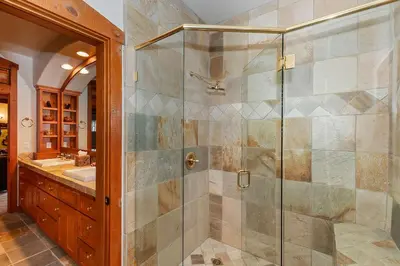 a bathroom with a shower with a glass door at Matternhorn Peak Lodge - For 10 in Lake Arrowhead
