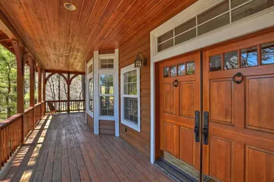 an empty porch of a home with wooden doors at Matternhorn Peak Lodge - For 10 in Lake Arrowhead