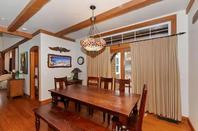 a dining room with a wooden table and chairs at Matternhorn Peak Lodge - For 10 in Lake Arrowhead
