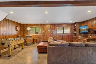 a living room with wood paneling and a ping pong table at Our Secret Getaway - Two Spacious Living Areas in Lake Arrowhead