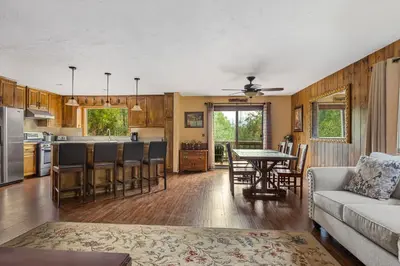 a kitchen and living room with a couch and a table at Our Secret Getaway - Two Spacious Living Areas in Lake Arrowhead