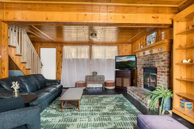 a living room with a couch and a fireplace at Pineland Getaway - Serene Escape in Green Valley Lake