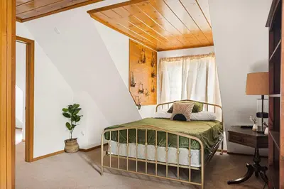 a bedroom with a bed and a window at Pineland Getaway - Serene Escape in Green Valley Lake