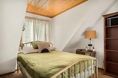 a bedroom with a bed and a window at Pineland Getaway - Serene Escape in Green Valley Lake