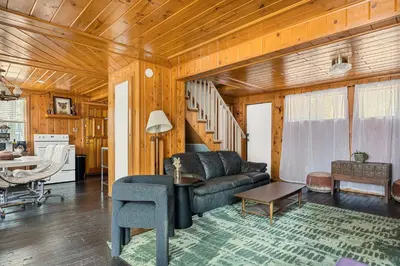 a living room with a couch and a table at Pineland Getaway - Serene Escape in Green Valley Lake