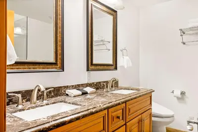 a bathroom with two sinks and two mirrors at Summit Pine Lodge - 2 Minutes to Snow Summit in Big Bear Lake