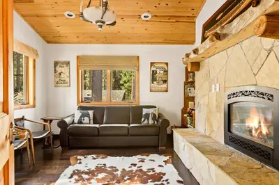 a living room with a couch and a fireplace at Summit Pine Lodge - 2 Minutes to Snow Summit in Big Bear Lake