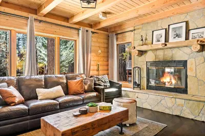 a living room with a leather couch and a fireplace at Summit Pine Lodge - 2 Minutes to Snow Summit in Big Bear Lake