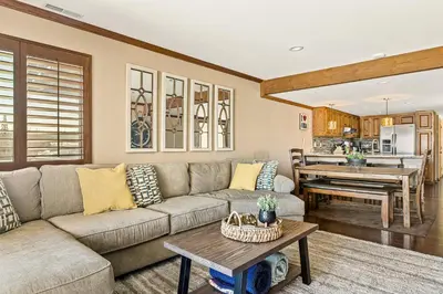 a living room with a couch and a table at The Adler's Nest - Lakefront with Pool Spa and Summer Dock in Big Bear Lake