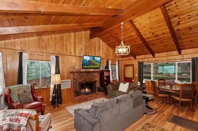 a living room with a couch and a fireplace at The Lazy Bear Cabin - For 6 in Crestline