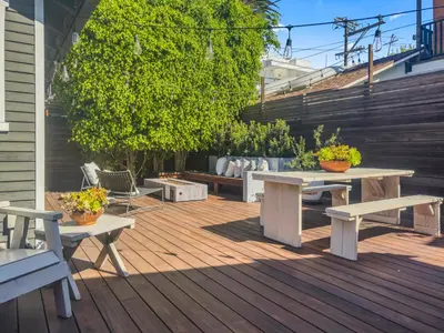 a patio with benches and tables on a deck at Venice 2BR - Ocean Walk with Stunning Outdoor Space! in Los Angeles