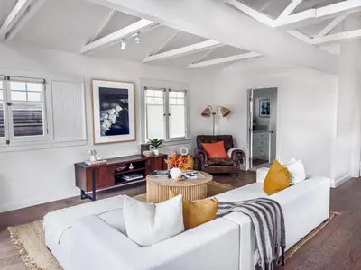 a living room with a white couch and a table at Venice 2BR - Ocean Walk with Stunning Outdoor Space! in Los Angeles