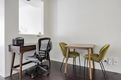 a desk and three chairs in a room at Blueground Venice pool AC nr beach LAX-1330 in Los Angeles