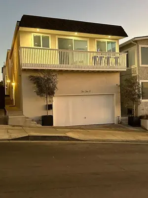 a house with a white garage door and a balcony at Manhattan Beach Modern Panoramic Sea View in Manhattan Beach