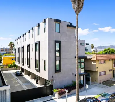 a building with a palm tree in front of it at Serene Hollywood in Los Angeles