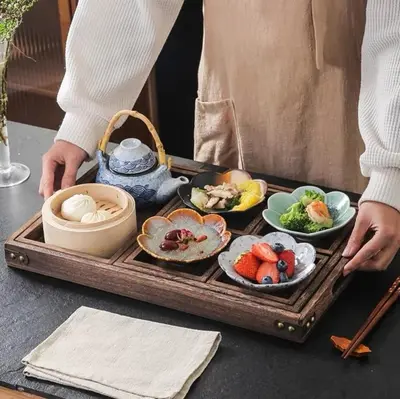 a person holding a tray of food on a table at Boy Travel in Hewitt