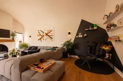 a living room with a couch and a table at Hauser House, Modern Artful Spanish-style Bungalow in Los Angeles