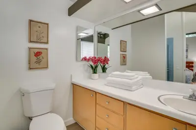 a bathroom with a sink and a toilet and a mirror at Ski, Hike and Explore! Twin Peaks Cabin with Deck in Twin Peaks