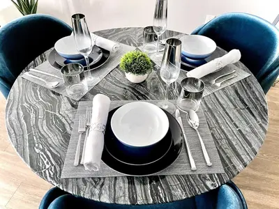 a table with plates and wine glasses on it at Sexy One Bedroom Apartment - Pool View & Parking in Los Angeles