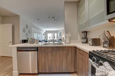 a kitchen with a sink and a stove top oven at Sexy One Bedroom Apartment - Pool View & Parking in Los Angeles