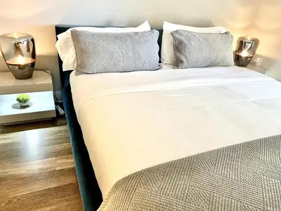 a bed with two pillows on it in a room at Sexy One Bedroom Apartment - Pool View & Parking in Los Angeles