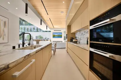 a large kitchen with a sink and a microwave at Hutton Villa in Los Angeles